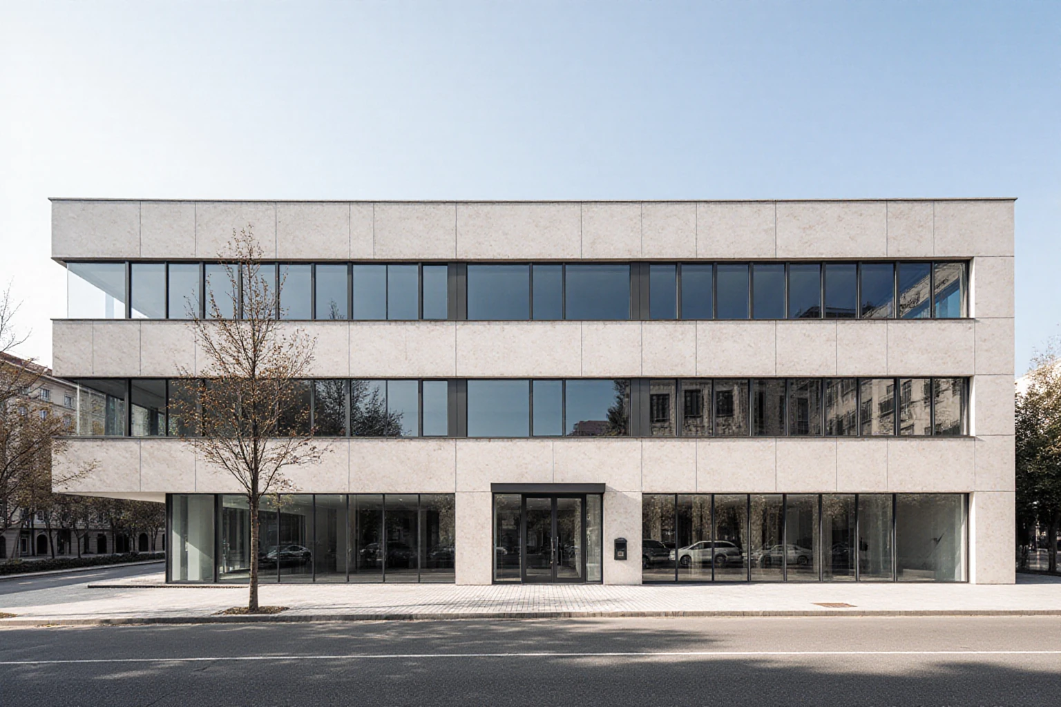 Multi-storey commercial building with a pale stone facade and large windows